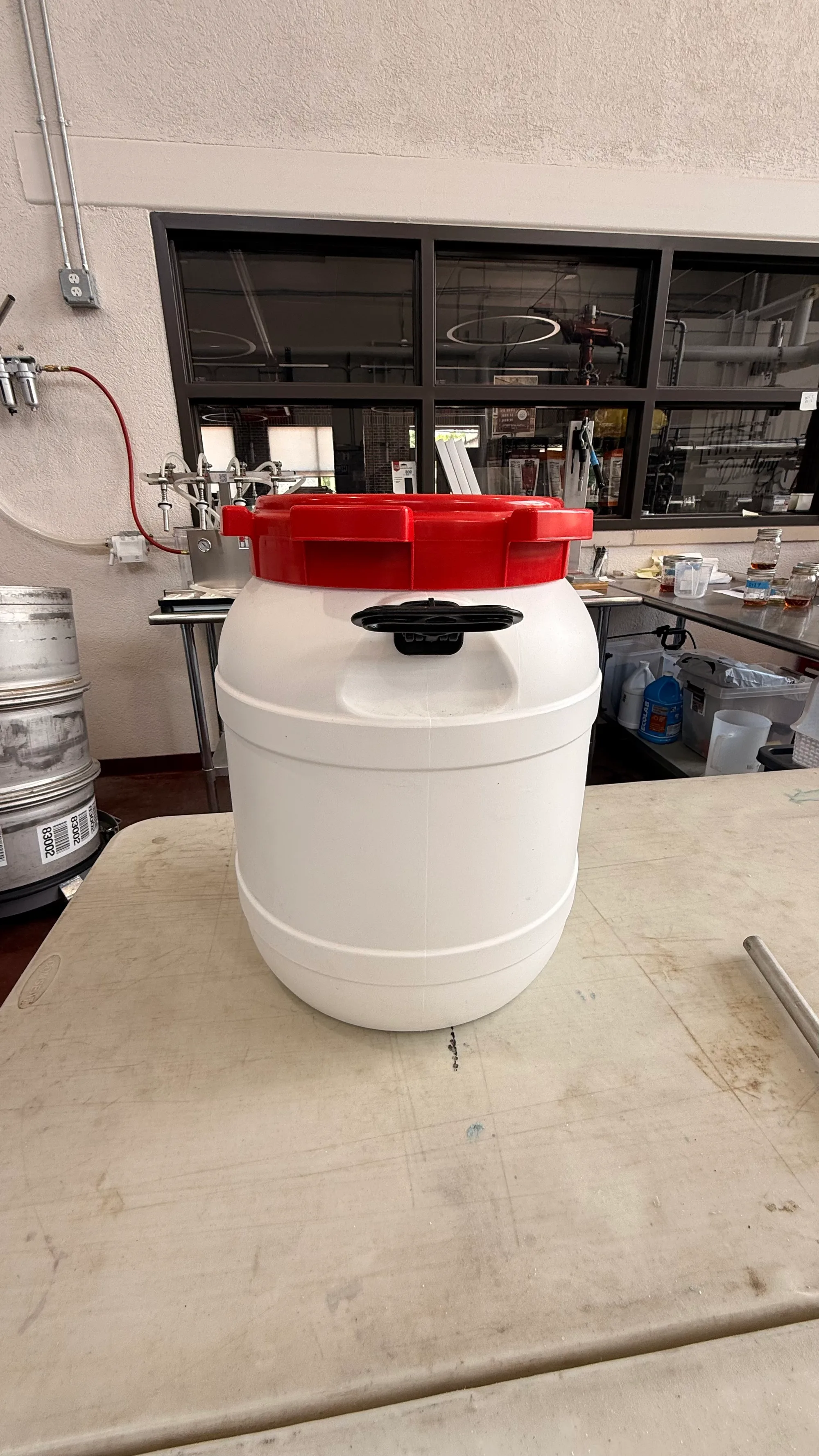 White plastic drums with red lid